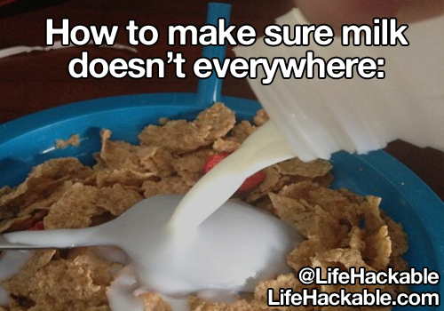 Image: Someone pouring milk into cereal by pouring it onto the back of an upturned spoon. Image text: How to make sure milk doesn't everywhere [sic].